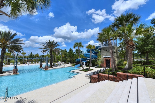 view of pool featuring a patio and a water slide