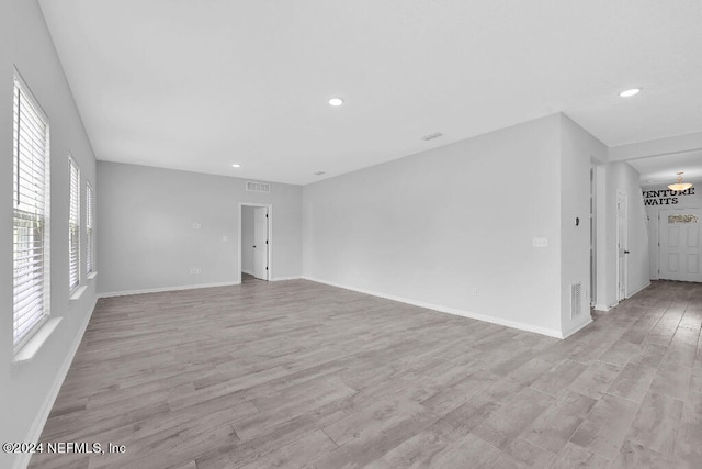 empty room featuring light hardwood / wood-style flooring and a healthy amount of sunlight