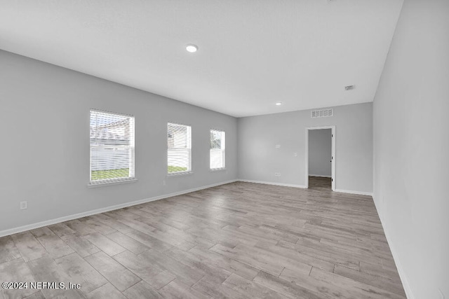 unfurnished room with light hardwood / wood-style floors