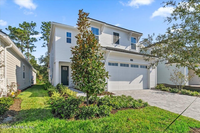 front of property featuring a garage and a front lawn