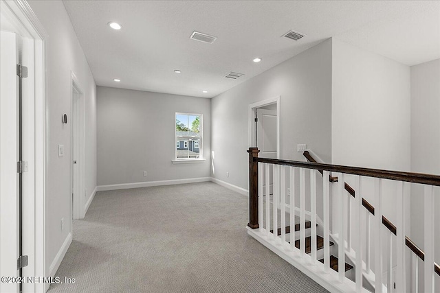 hallway with light carpet