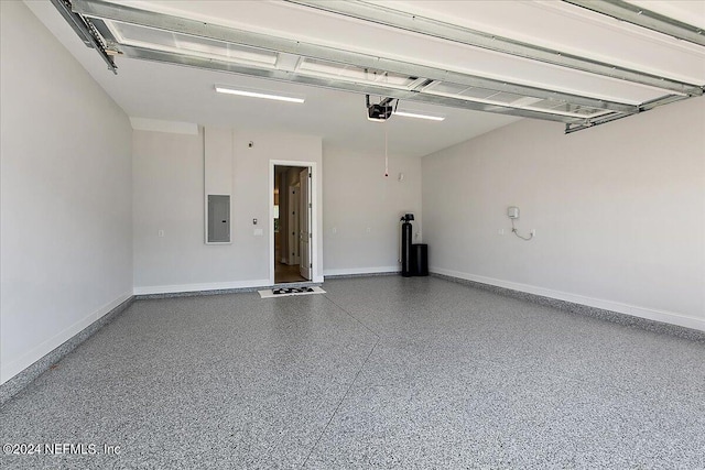 garage featuring a garage door opener and electric panel