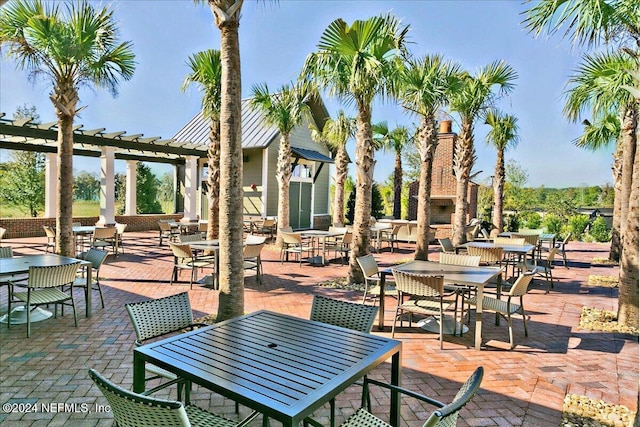 view of patio / terrace featuring an outdoor stone fireplace