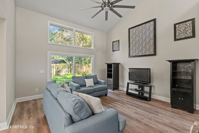 living room featuring ceiling fan, high vaulted ceiling, and light wood-type flooring