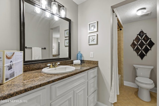 full bathroom with tile patterned floors, toilet, shower / tub combo with curtain, vanity, and a textured ceiling