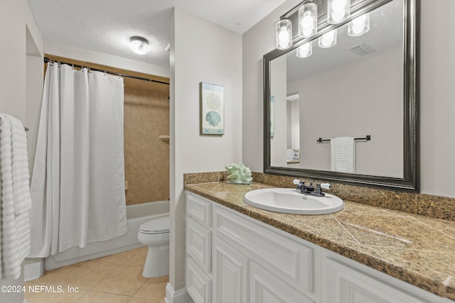 full bathroom with shower / bath combination with curtain, a textured ceiling, toilet, vanity, and tile patterned flooring