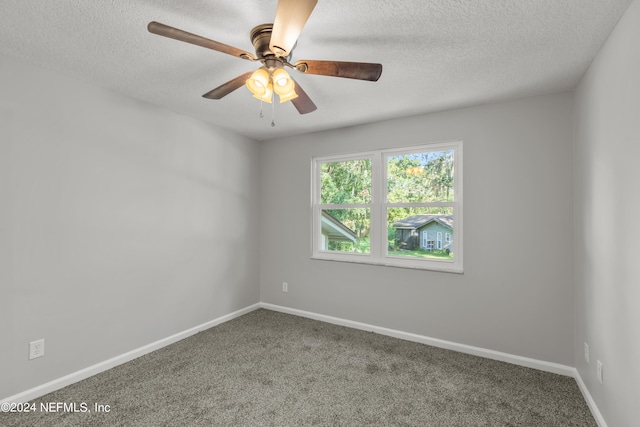 spare room with carpet, a textured ceiling, and ceiling fan