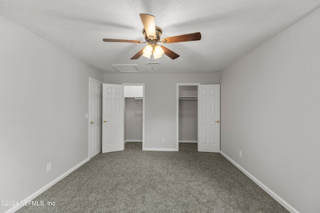 unfurnished bedroom featuring ceiling fan, a textured ceiling, and dark colored carpet