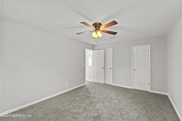 carpeted empty room featuring a textured ceiling and ceiling fan