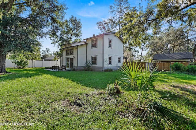 rear view of house with a yard