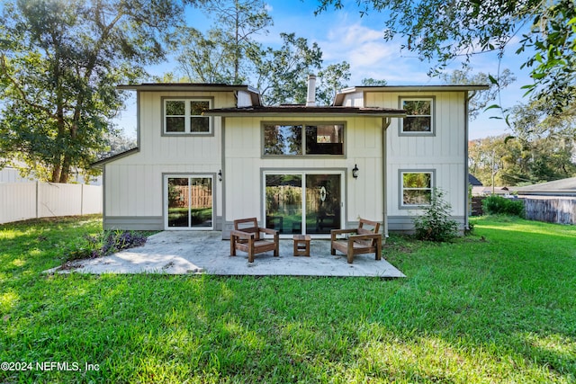 back of house with a yard and a patio area