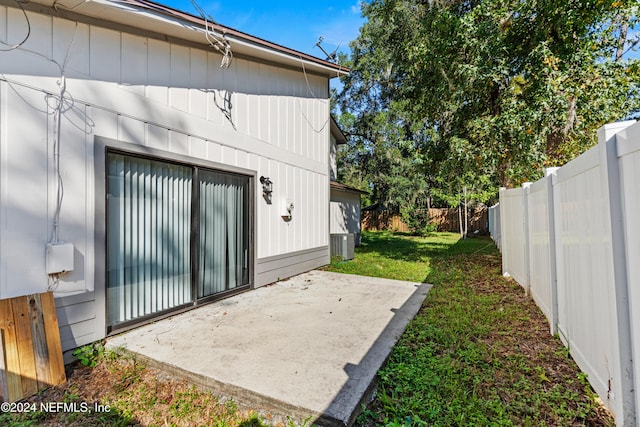 exterior space with a patio area and a lawn