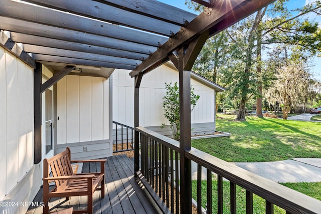 wooden terrace with a lawn and a pergola