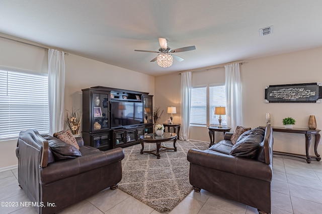 tiled living room with ceiling fan