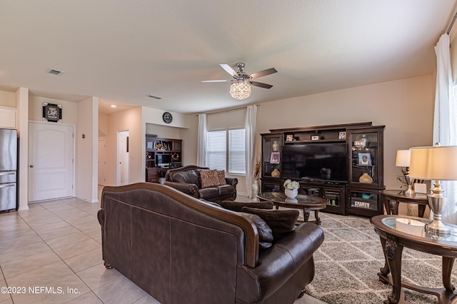 living room featuring light tile patterned floors and ceiling fan