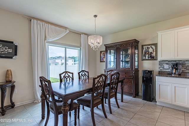 dining area with an inviting chandelier and light tile patterned floors