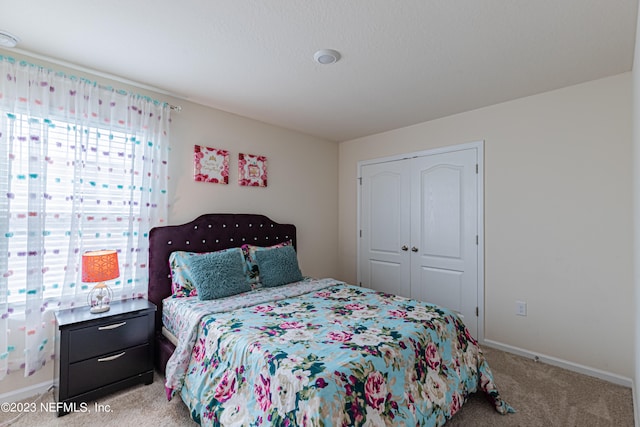 carpeted bedroom with a closet