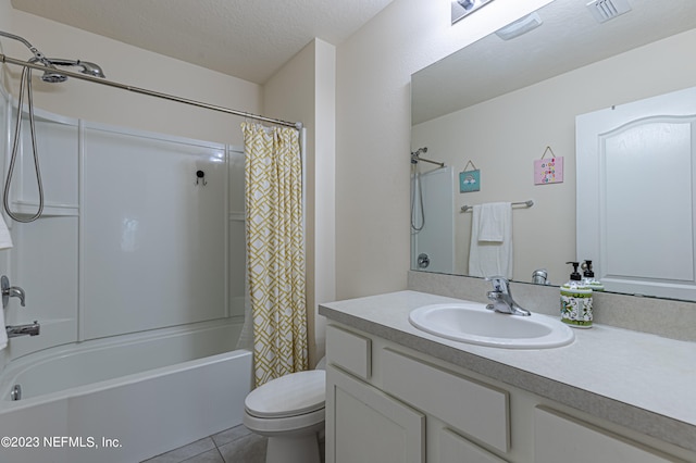 full bathroom with shower / tub combo, vanity, tile patterned flooring, toilet, and a textured ceiling