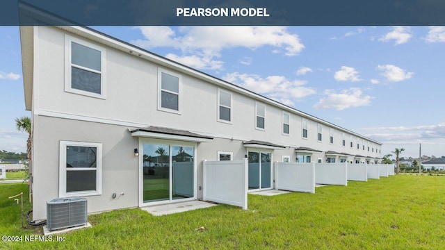 rear view of property with a yard and central air condition unit