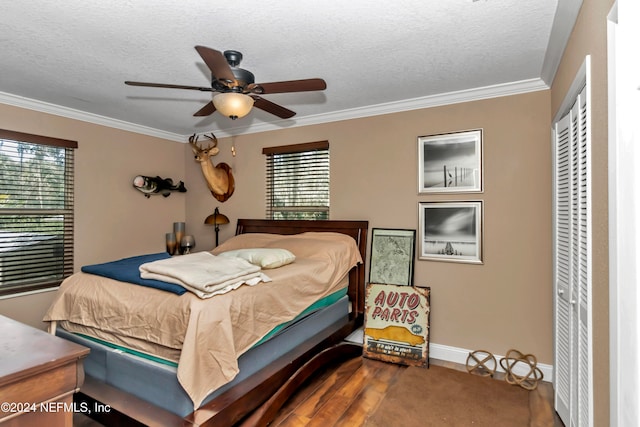 bedroom featuring ceiling fan, wood-type flooring, a textured ceiling, a closet, and crown molding