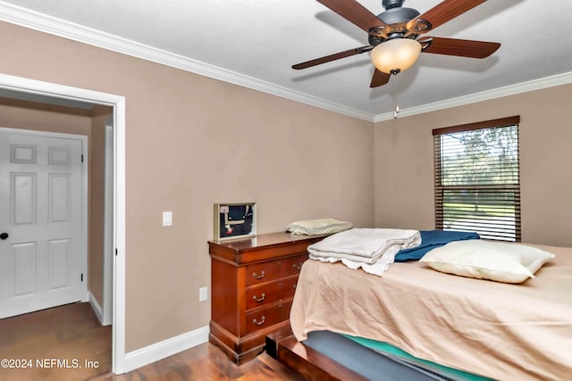 bedroom with dark hardwood / wood-style floors, crown molding, and ceiling fan