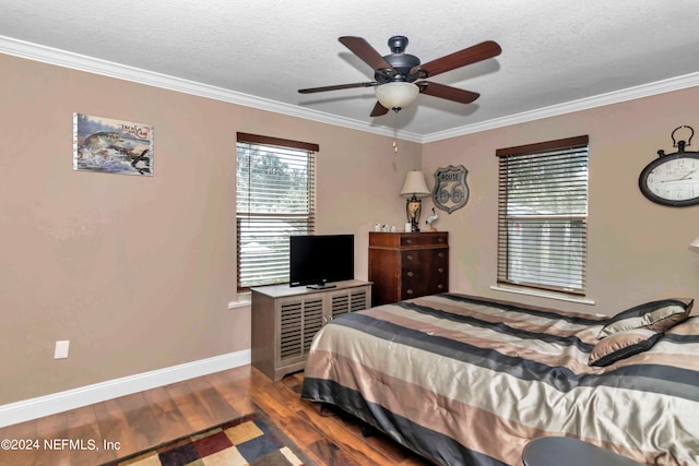 bedroom featuring ornamental molding, ceiling fan, a textured ceiling, and dark hardwood / wood-style flooring