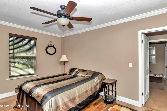 bedroom with ornamental molding, hardwood / wood-style floors, a textured ceiling, and ceiling fan