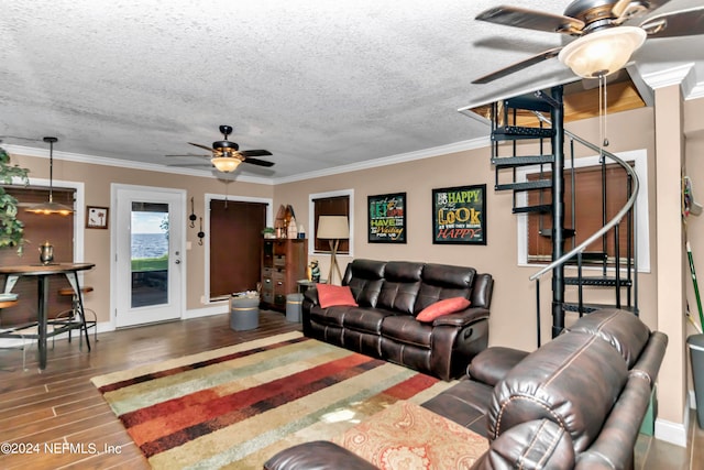 living room featuring ceiling fan, a textured ceiling, crown molding, and hardwood / wood-style floors