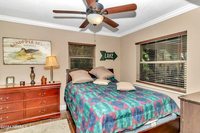 bedroom featuring ceiling fan, hardwood / wood-style flooring, and ornamental molding