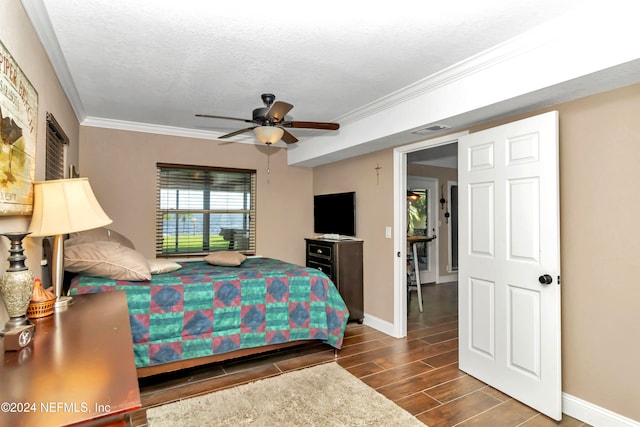 bedroom featuring ornamental molding, dark hardwood / wood-style flooring, a textured ceiling, and ceiling fan