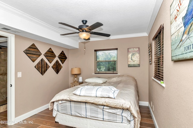 bedroom featuring ceiling fan, crown molding, dark wood-type flooring, a closet, and a textured ceiling