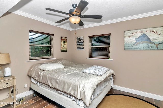 bedroom with ceiling fan, a textured ceiling, dark hardwood / wood-style floors, and ornamental molding