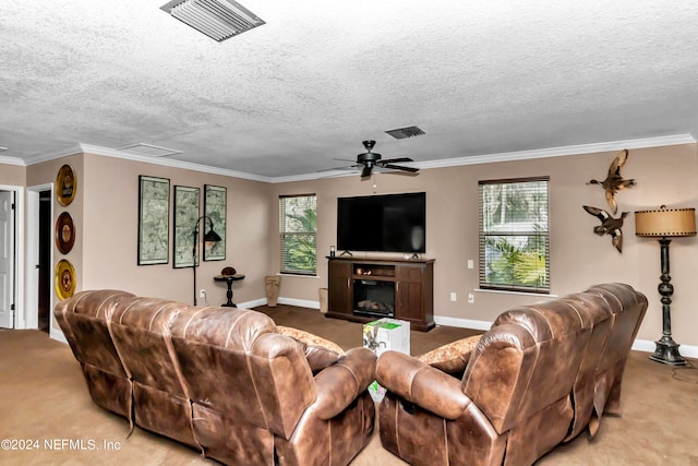 carpeted living room with ceiling fan, a textured ceiling, and a wealth of natural light