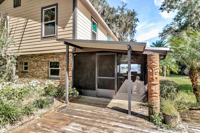 back of house featuring a sunroom and a deck