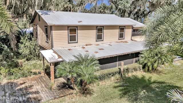 rear view of property with a lawn