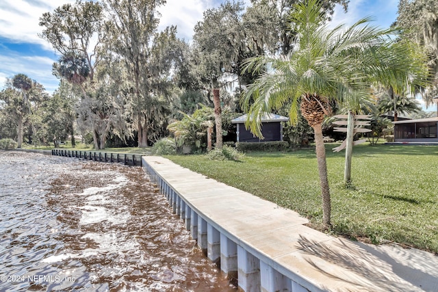 view of home's community featuring a lawn and a water view