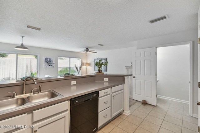 kitchen featuring white cabinets, dishwasher, sink, decorative light fixtures, and a textured ceiling