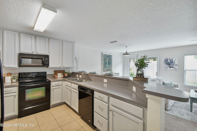 kitchen featuring black appliances, white cabinets, sink, kitchen peninsula, and a textured ceiling