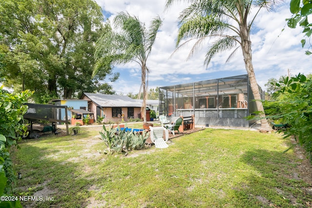 view of yard with a lanai and a swimming pool