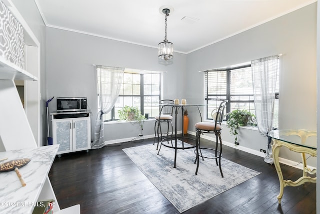 living area with ornamental molding, a notable chandelier, and dark hardwood / wood-style flooring