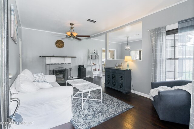 living room featuring ceiling fan, ornamental molding, and dark hardwood / wood-style flooring