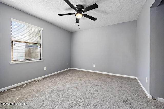 empty room with a textured ceiling, carpet floors, and ceiling fan