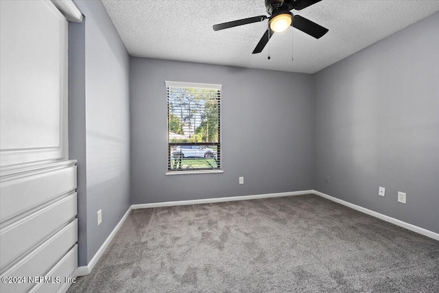 carpeted empty room featuring a textured ceiling and ceiling fan