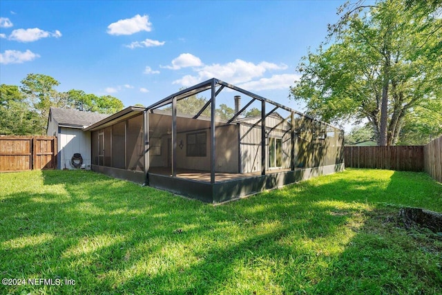 back of property with a lanai and a lawn