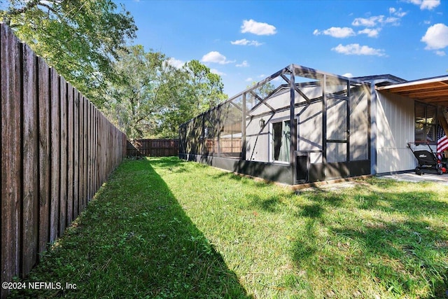 view of yard with glass enclosure