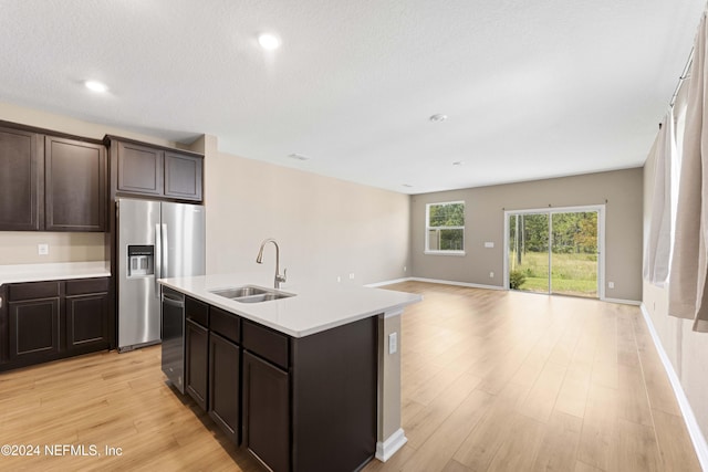 7716 Merchants Way, Jacksonville, FL 32222 - kitchen featuring a sink, appliances with stainless steel finishes, light countertops, dark brown cabinetry, and light wood-type flooring
