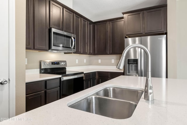7716 Merchants Way, Jacksonville, FL 32222 - kitchen with dark brown cabinets, light stone counters, appliances with stainless steel finishes, and a sink