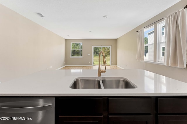 7716 Merchants Way, Jacksonville, FL 32222 - kitchen featuring stainless steel dishwasher, light countertops, a sink, visible vents, and open floor plan