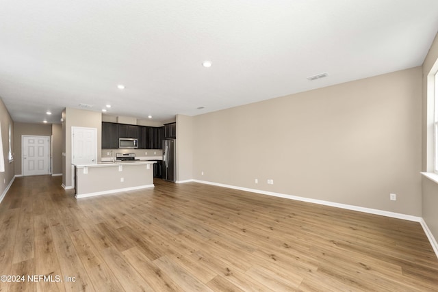 7716 Merchants Way, Jacksonville, FL 32222 - unfurnished living room featuring baseboards, recessed lighting, visible vents, and light wood-style floors