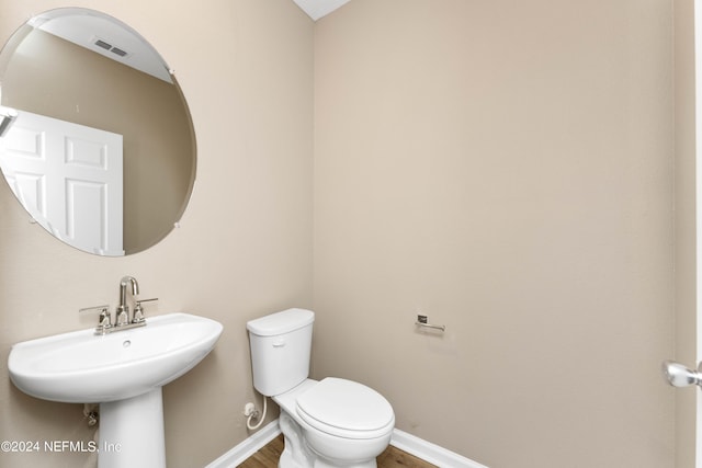 7716 Merchants Way, Jacksonville, FL 32222 - bathroom featuring wood finished floors, toilet, a sink, baseboards, and visible vents